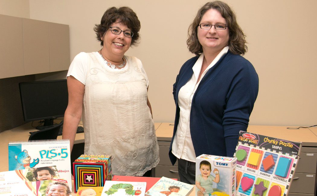 Lori Chleborad, CYFS project coordinator, and Dawn Davis, CYFS project manager, prepare materials for families participating in an evaluation of the Superintendents’ Early Childhood Plan. Davis is leading an evaluation of home visitations for children birth to age 3.
