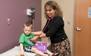 Cristina Fernandez with a patient at Children's Physicians in Omaha, Nebraska. Fernandez is co-investigator for the PHIT study.