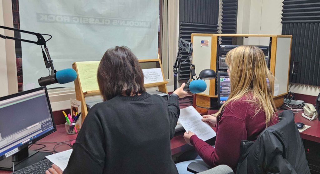 Student from Jacht advertising agency records a radio spot at station using microphone.