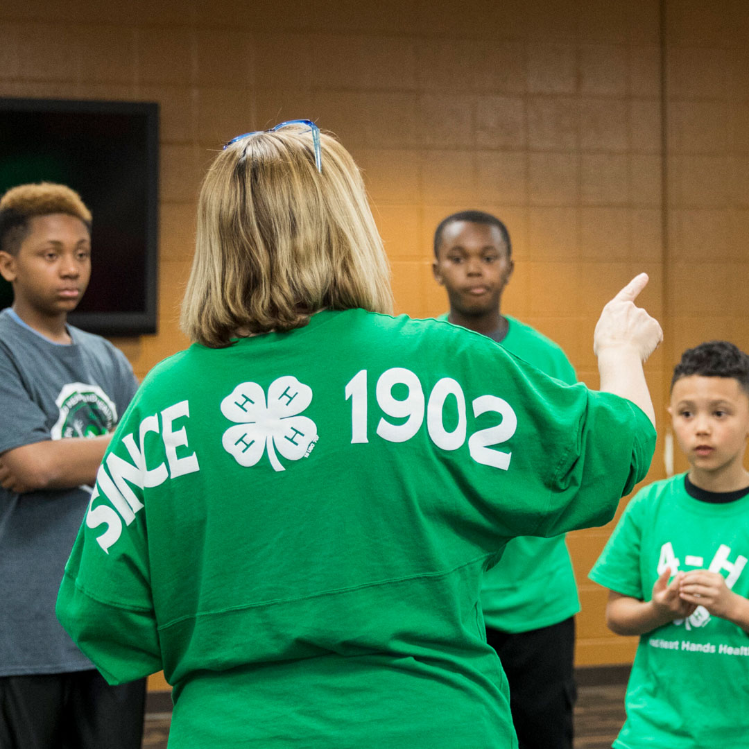 4-H instructor speaking to a group of youth.